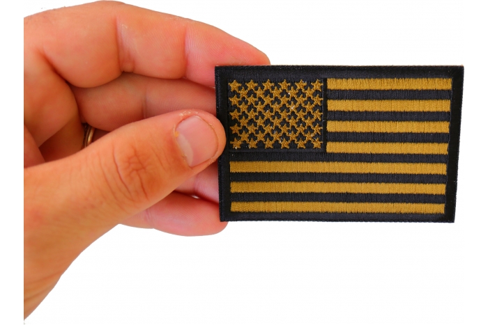 Subdued Green US Flag Patch shown on hand for size comparison