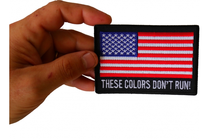 These Colors Don't Run US Flag Patch shown on hand for size comparison