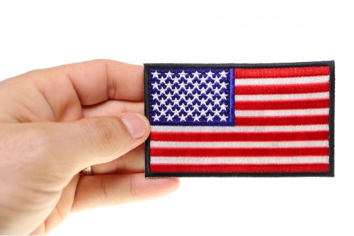 US Flag Patch 4 Inch Black Border shown on hand for size comparison