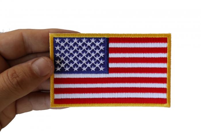 US Flag Patch 4 Inch Yellow Border shown on hand for size comparison