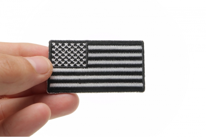 US Flag Patch Black and White 2.5 Inch shown on hand for size comparison