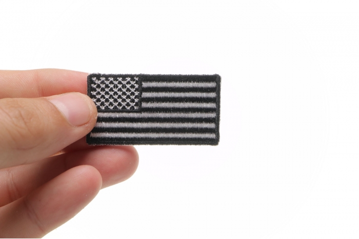 US Flag Patch Black and White 2 Inch shown on hand for size comparison