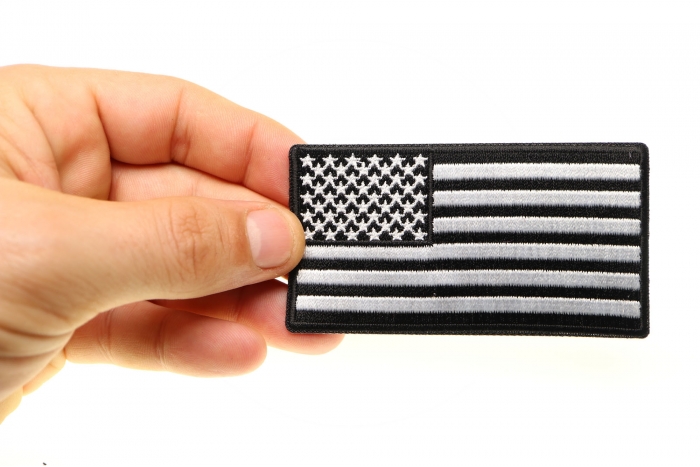 US Flag Patch Black and White 3.5 Inch shown on hand for size comparison