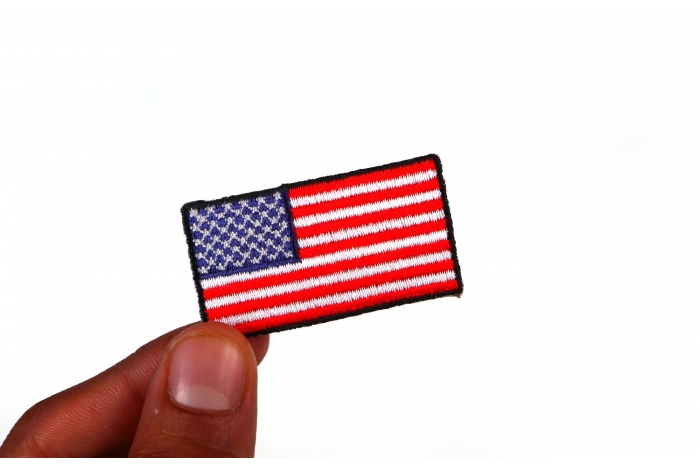 US Flag Patch Black Border 2 Inch shown on hand for size comparison