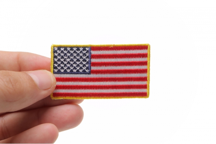 US Flag Patch Gold Border 2.5 Inch shown on hand for size comparison