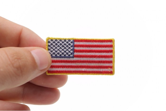 US Flag Patch Gold Border 2 Inch shown on hand for size comparison