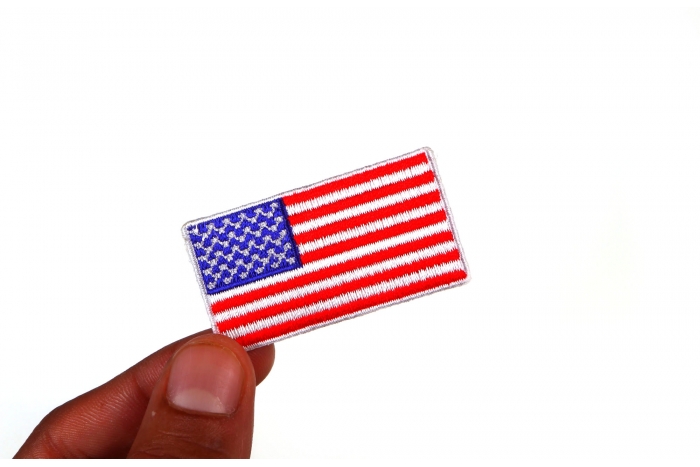 US Flag Patch White Border 2 Inch shown on hand for size comparison