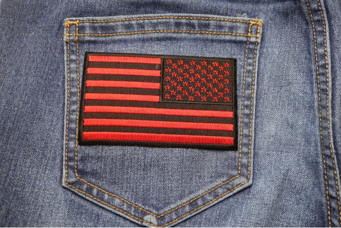 Black and Red Reversed American Flag Patch 4 Inch shown on jeans