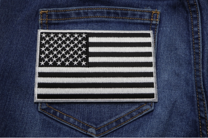 Black and White American Flag Patch with White Borders shown on jeans