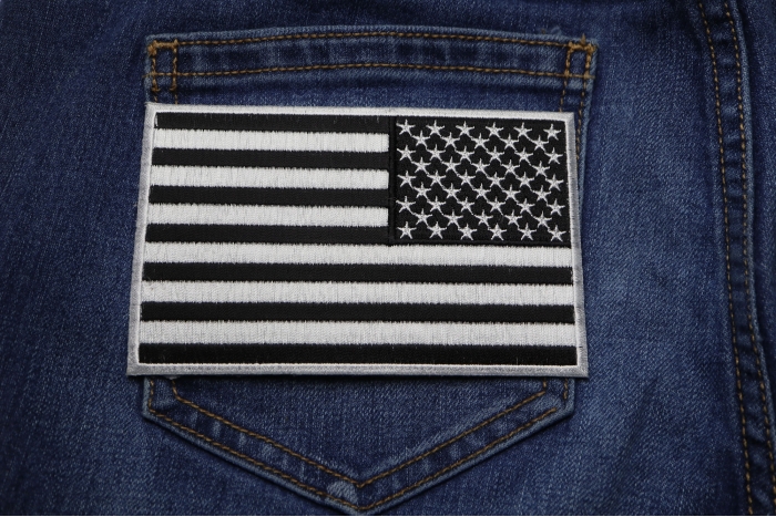 Black and White American REVERSED Flag Patch with White Borders shown on jeans