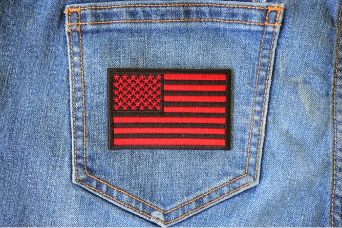 Red Black American Flag Patch shown on jeans