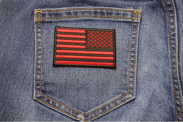 Reversed Red American Flag Patch shown on jeans