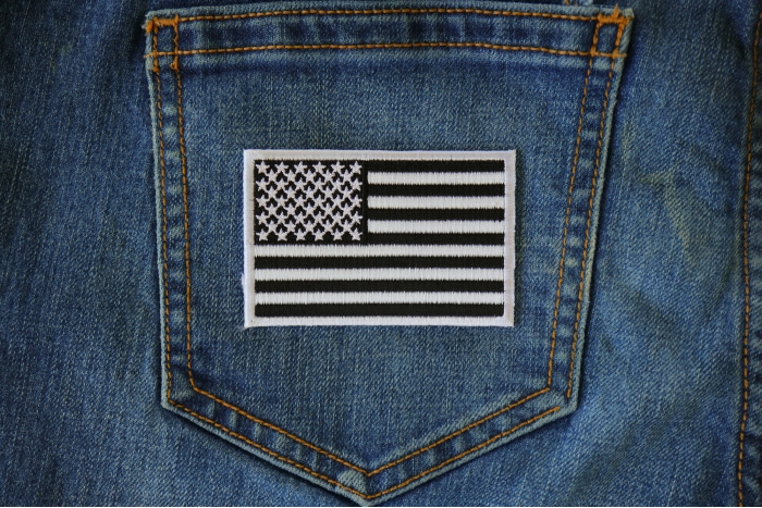 Subdued Black White US Flag Patch shown on jeans