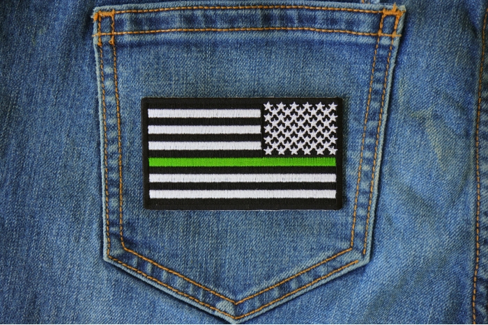Thin Green Line American Flag Reversed Patch shown on jeans