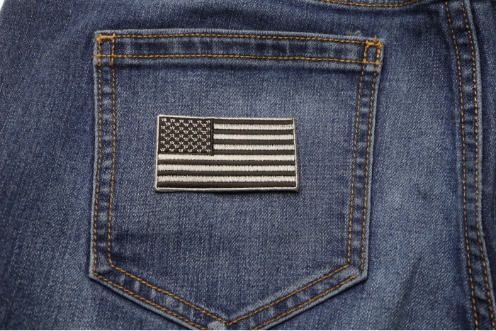 US Flag Patch Black and Gray 2.5 Inch shown on jeans