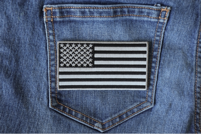 US Flag Patch Black and Gray 4 Inch shown on jeans