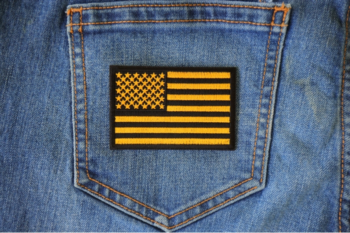 Yellow Black American Flag Patch shown on jeans