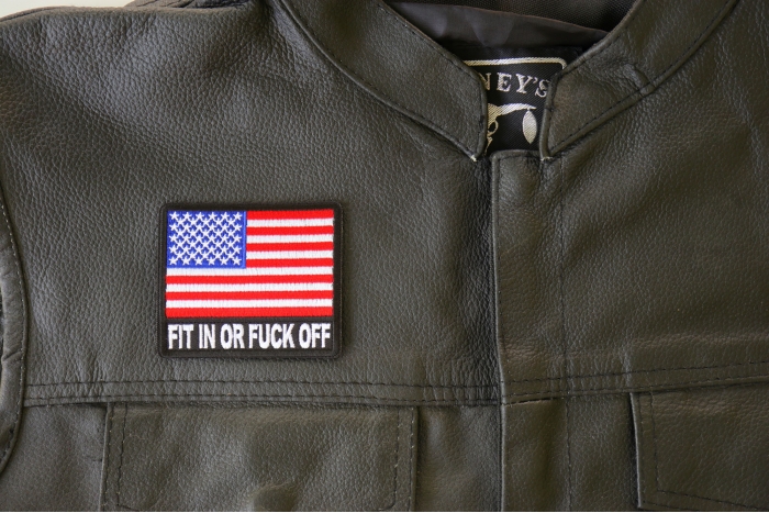 Fit in or Fuck Off USA Flag Patch - 3x2.6 inch. Embroidered Iron on Patch shown on leather vest