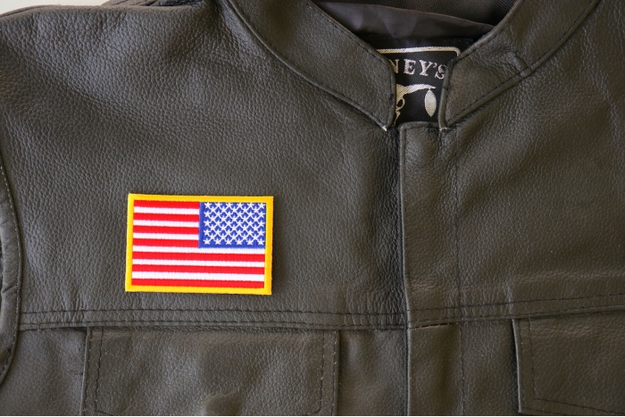 Reversed American Flag Patch - 3x2 inches. Embroidered Iron on Patch shown on leather vest