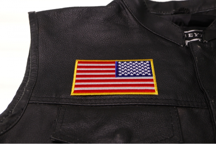 Reversed US Flag Patch 4 Inch Yellow Border - 4x2.5 inch. Embroidered Iron on Patch shown on leather vest