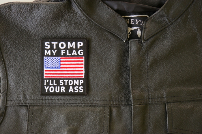 Stomp My Flag I'll Stomp Your Ass American Flag Patch - 3x3.6 inch. Embroidered Iron on Patch shown on leather vest