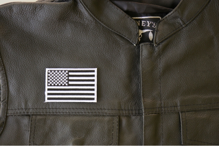 Subdued Black White US Flag Patch - 3x2 inch. Embroidered Iron on Patch shown on leather vest