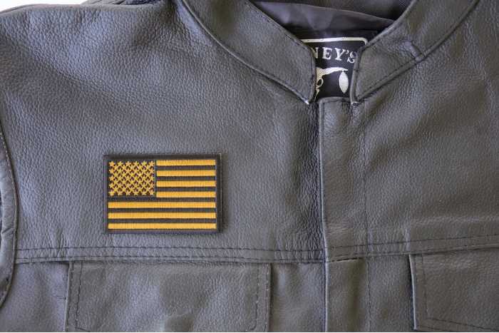 Subdued Green US Flag Patch - 3x2 inch. Embroidered Iron on Patch shown on leather vest