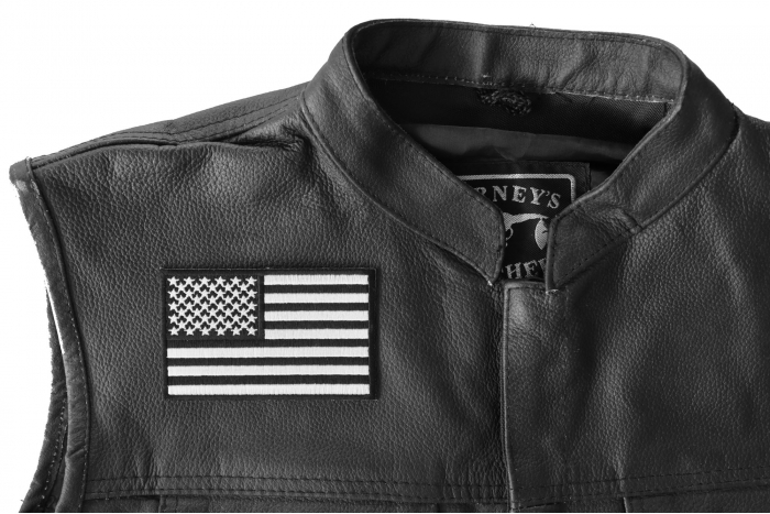 US Flag Black White Patch 4 Inch - 4x2.5 inch. Embroidered Iron on Patch shown on leather vest