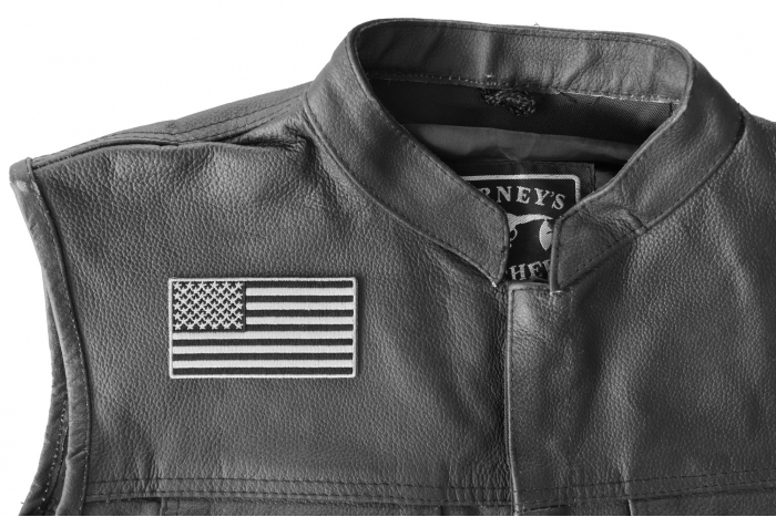 US Flag Patch Black and Gray 3.5 Inch - 3.5x1.9 inch. Embroidered Iron on Patch shown on leather vest