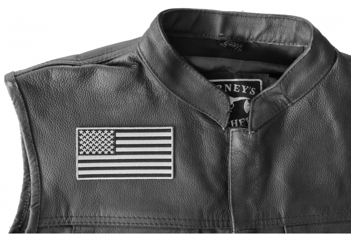 US Flag Patch Black and Gray 4 Inch - 4x2.2 inch. Embroidered Iron on Patch shown on leather vest