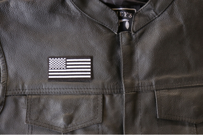 US Flag Patch Black and White 3 Inch - 3x1.6 inch. Embroidered Iron on Patch shown on leather vest
