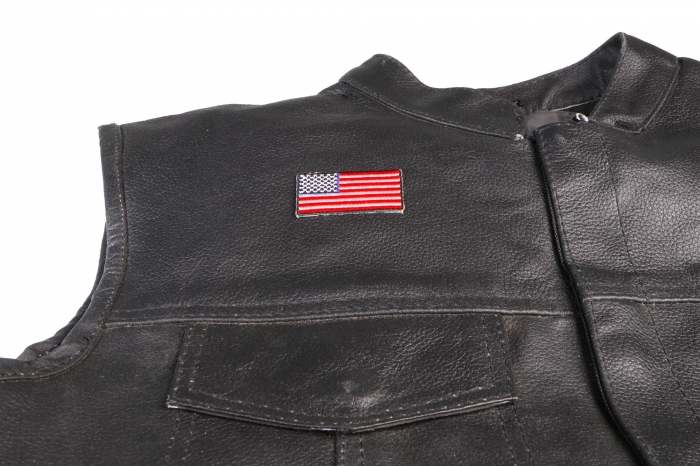 US Flag Patch Black Border 2 Inch - 2x1.1 inch. Embroidered Iron on Patch shown on leather vest