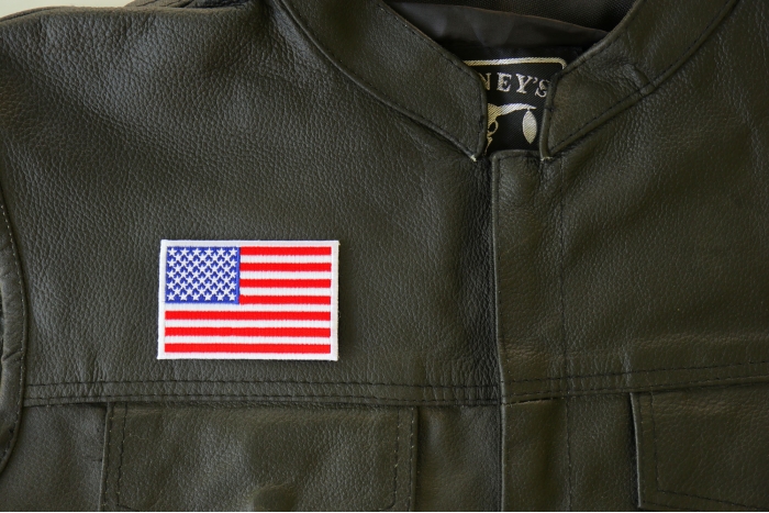 US Flag White Border Patch - 3x2 inch. Embroidered Iron on Patch shown on leather vest
