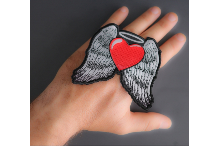 Guardian Angel Heart Patch shown on hand for size comparison