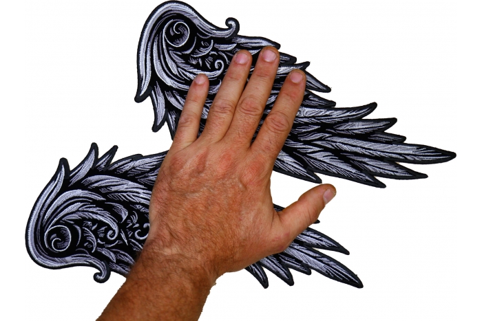 Silver Angel Wings Patch shown on hand for size comparison