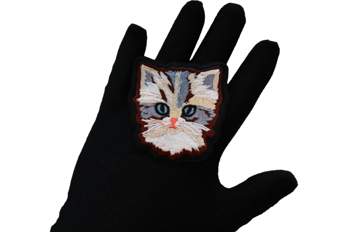 Adorable Cat Iron on Patch shown on hand for size comparison