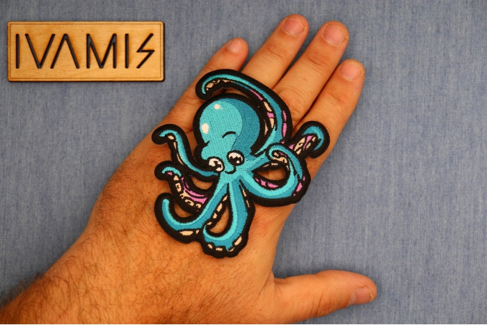 Baby Octopus Patch shown on hand for size comparison