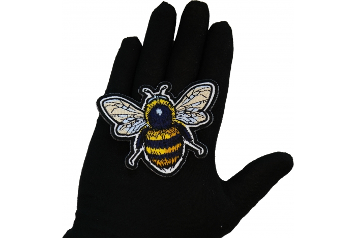 Bee Patch shown on hand for size comparison