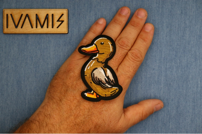 Brown Duck Patch shown on hand for size comparison