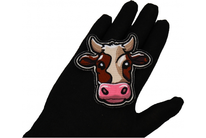 Cartoon Cow Patch shown on hand for size comparison