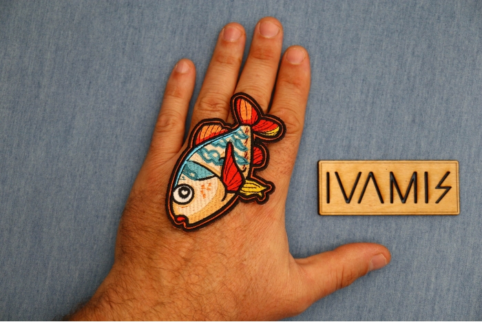 Cartoonish Fish Patch shown on hand for size comparison
