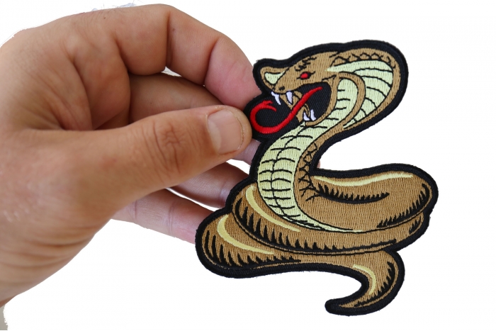 Cobra Patch shown on hand for size comparison