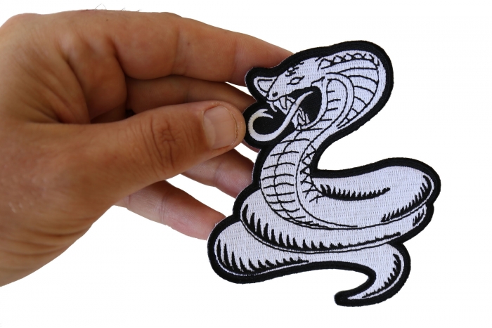 Cobra White Patch shown on hand for size comparison