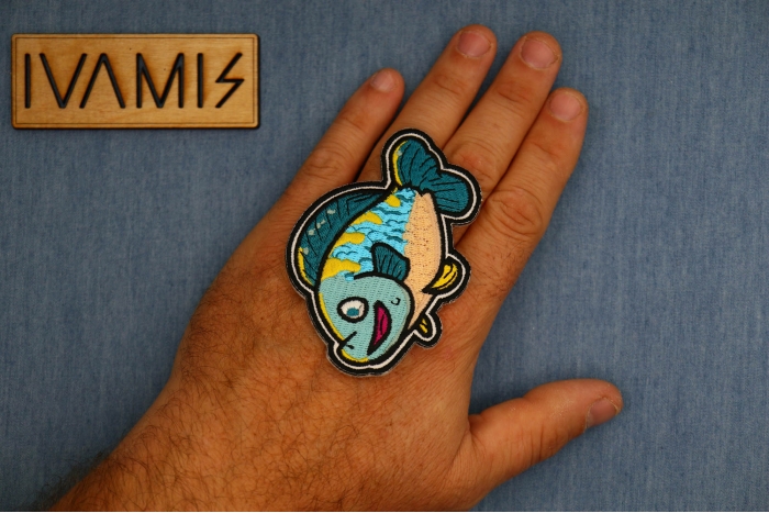 Cute Fish Patch shown on hand for size comparison