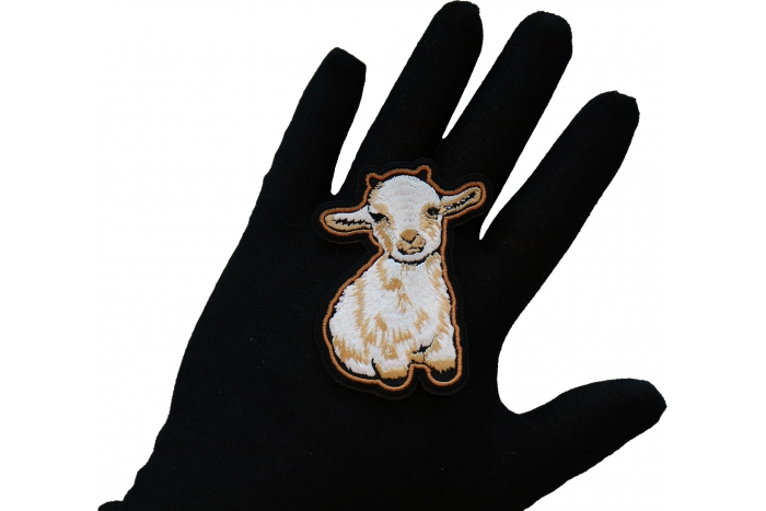 Cutey Lamb Iron on Patch shown on hand for size comparison