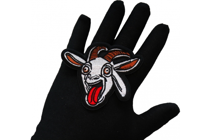 Funny GOAT Iron on Patch shown on hand for size comparison