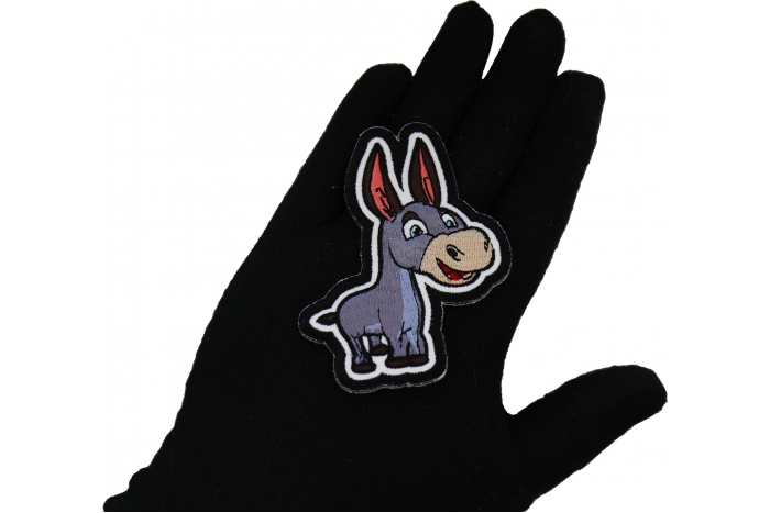 Happy Donkey Patch shown on hand for size comparison
