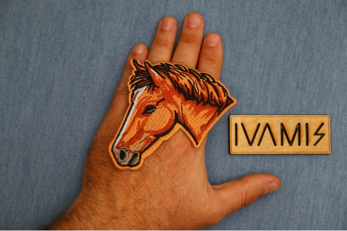 Horse Head Patch shown on hand for size comparison