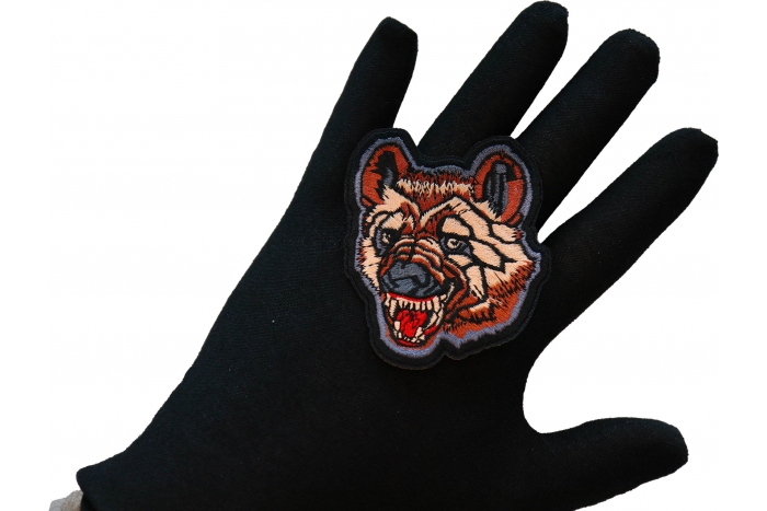 Hyena Iron on Patch shown on hand for size comparison