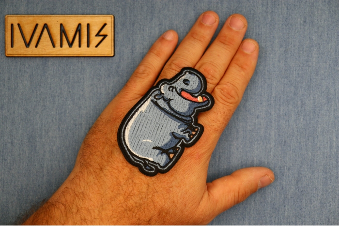 Laughing Hippo Patch shown on hand for size comparison